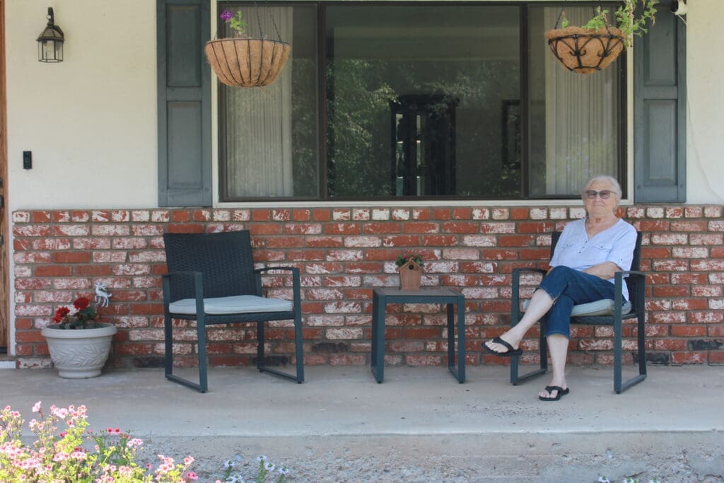 Woman sitting in a repaired home